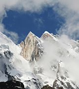 High mountain peaks obscured by clouds.