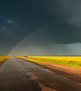 Rainbow at the end of a road.