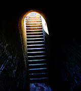 Photo of a stone staircase leading upwards.