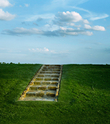 A stone staircase on a grassy hillside.