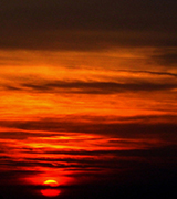 Vivid sunset reflected in dark water.