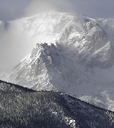 Snow blowing off mountain peaks.